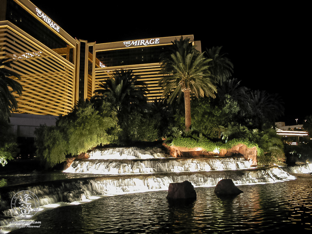 Mirage Casino and its lagoon lit up at night.