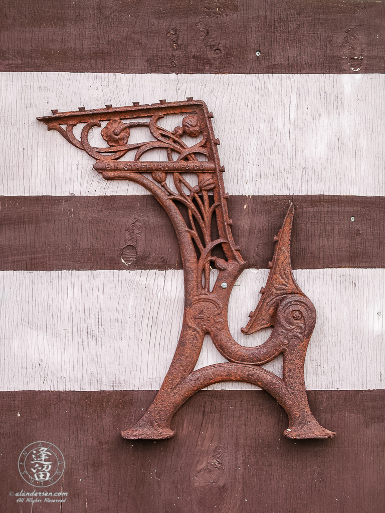 Iron ornament attached to old schoolhouse door.