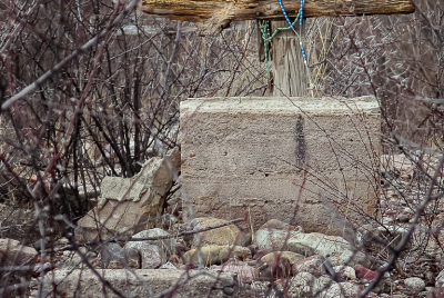 Gone But Not Forgotten Wooden cross grave marker draped with torquoise rosary.