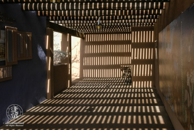 Sunlight and shadow create dizzy patterns on walls.