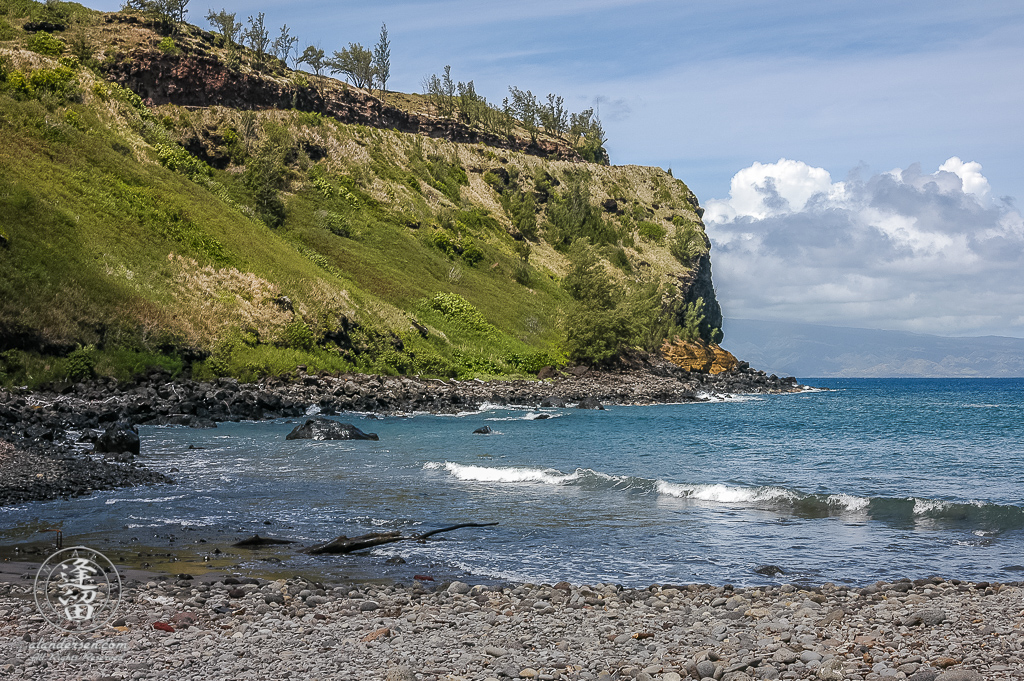 Kahekili Hwy 30 curves down off the cliffs on the Maui coast at Honokohau Bay.