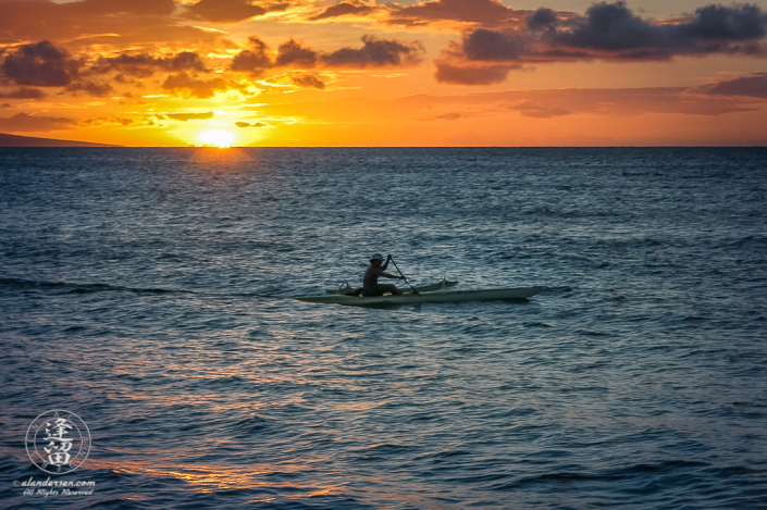 Canoer paddling along the Kaanapali coast at sunset.