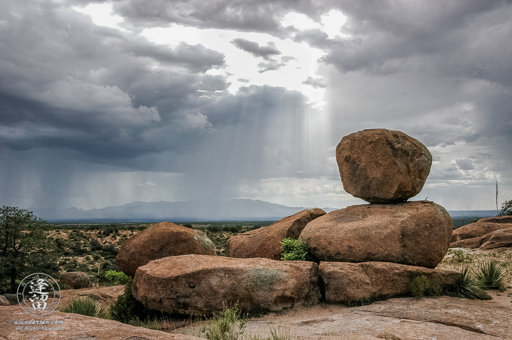 Summer Monsoon rainstorm sweeping across a desert valley.