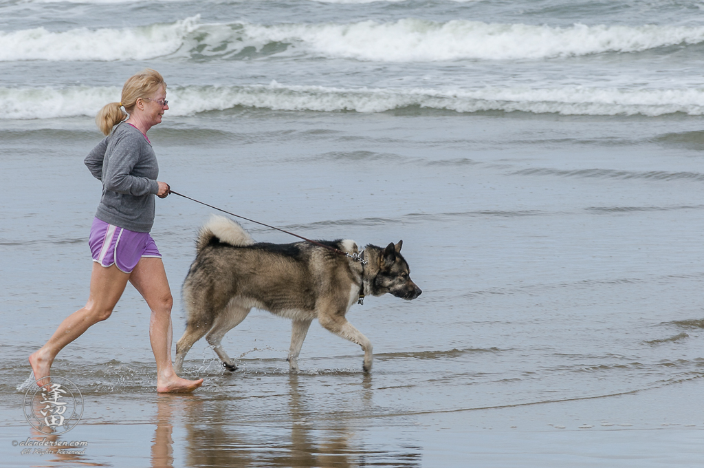 Hachi and Lori running on the beach in Oregon.