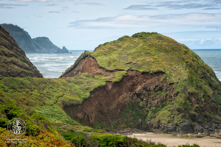 Eroded round grass-covered hill on Oregon coast.