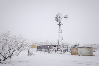Windmill And Snow Thick snow blanketing windmill and corrals