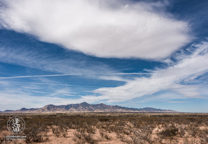 Cirrus clouds streaming above Arizona's Huachuca Mountains.