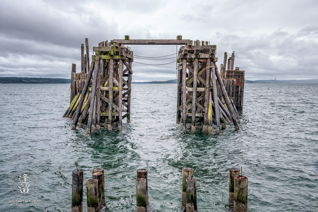 Old wooden ferry dock just off shore in historic downtown Port Townsend, Washington.