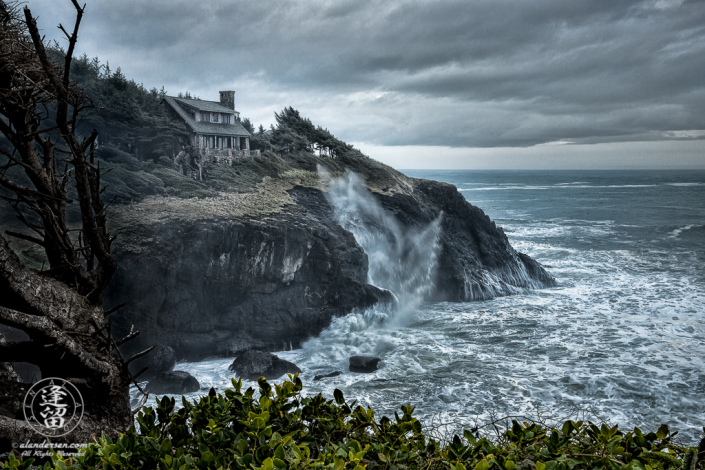 House atop cliffs at Otter Crest Loop during stormy day.