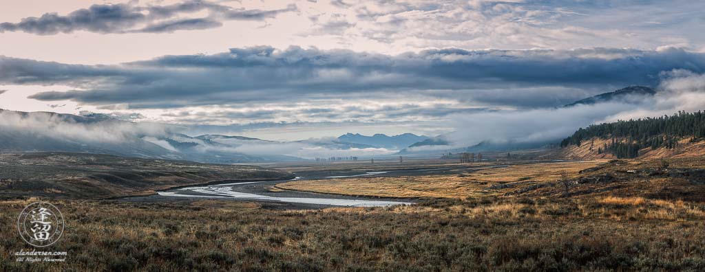 A panorama of Lamar Valley in Yellowstone National Park, filled with clouds on a cold and wet Autumn morning.