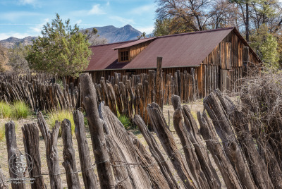 Camp Rucker Barn And Fence Closeup stockaded barn surrounded by wire-woven log fence at historic Camp Rucker.