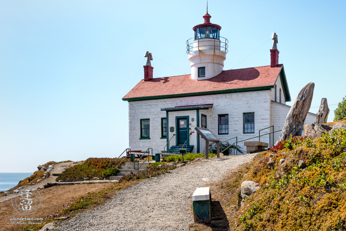 Front view of Battery Point Lighthouse sitting atop hill at Crescent City in Northern California.