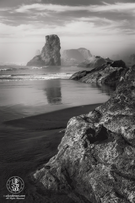 Various sea stacks at Bandon Beach in Oregon on a misty afternoon.