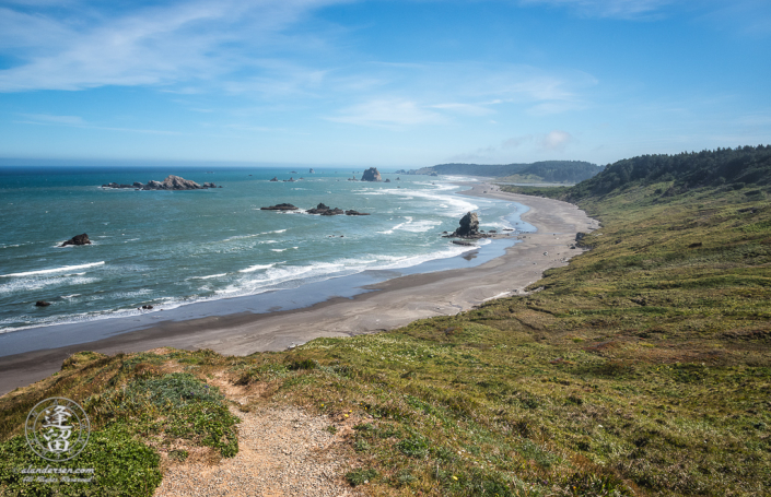 Scenic view of windswept grassy hills and rugged coastline at Cape Blanco State Park in Oregon..