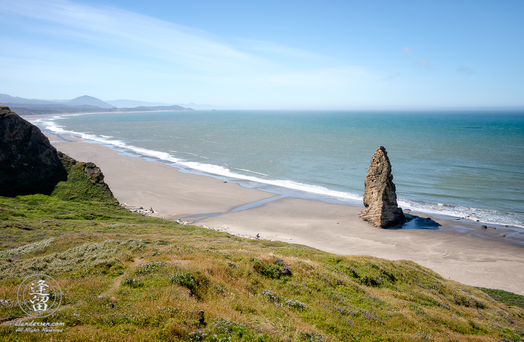A solitary sea stack jutting up from the beach just south of the Cape Blanco Lighthouse at Cape Blanco State Park outside of Port Orford in Oregon.