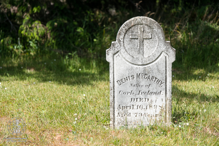 The tombstone for Denis McCarthy in the Cape Blanco Pioneer Cemetery at Cape Blanco State Park, outside of Port Orford in Oregon.