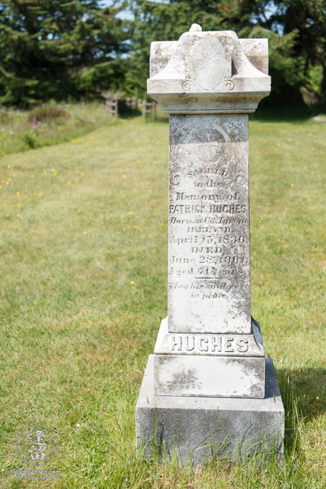 Tombstone for Hughes family patriarch, Patrick Hughes, in the Cape Blanco Pioneer Cemetery at Cape Blanco State Park, outside of Port Orford in Oregon.