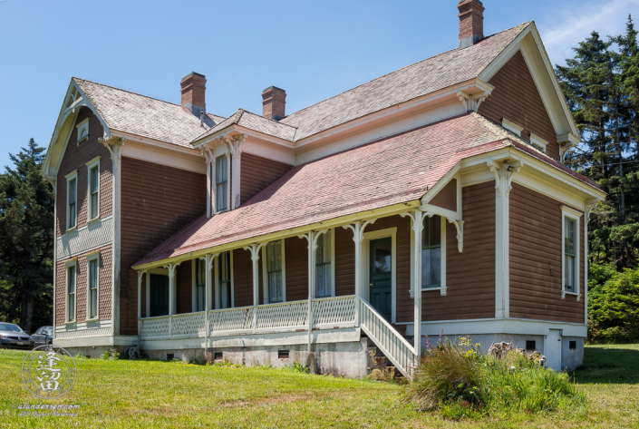 Outside view of the historic Hughes House near Port Orford, Oregon, showing porch outside kitchen.