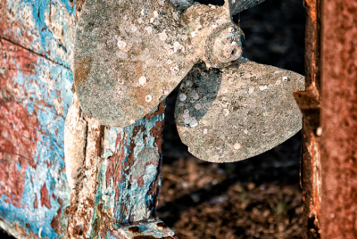 Propeller On Abandoned Boat An old rusted and rotted boat (the Pisces) in dry dock on Starfish Way, by the Marina at Crescent City in Northern California.