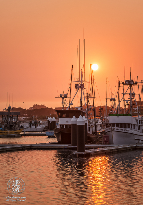 Smoke from Oregon wildfires turn the sky orange during a sunset at the Crescent City Marina in Northern California.