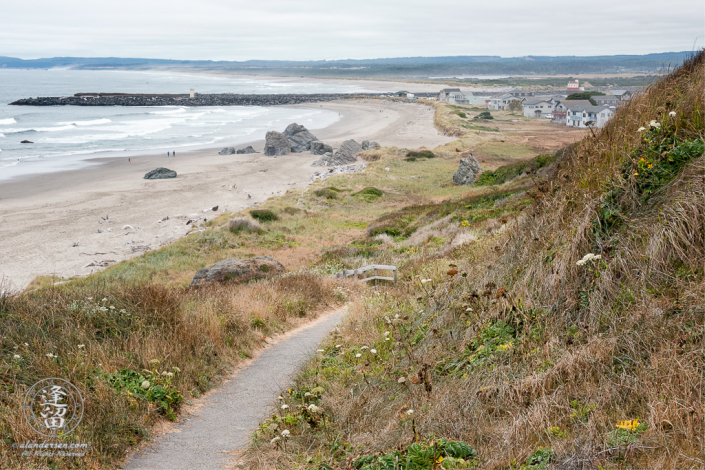 Paved path down to beach above Coquille Point in Bandon, Oregon, looking toward Bandon South Jetty Park.