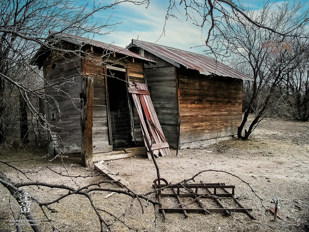 Wooden storage shed and attached outhouse.