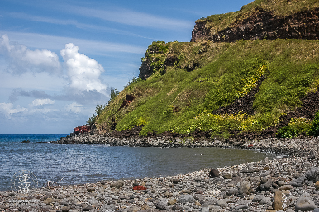 Kahekili Hwy 340 curves down off the cliffs on the Maui coast at Honokohau Bay.