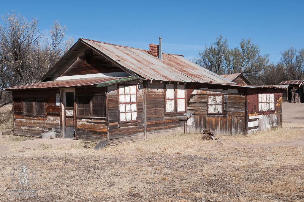 Ruins of an old weathered wooden house.