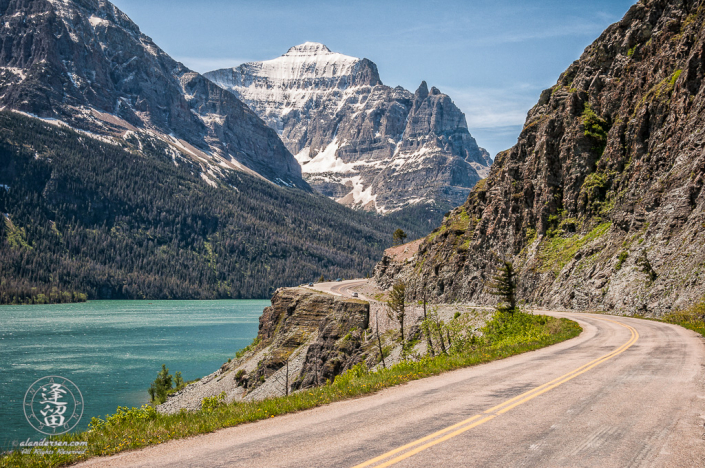 Going To The Sun Road curving around cliff before towering Little Chief mountain.