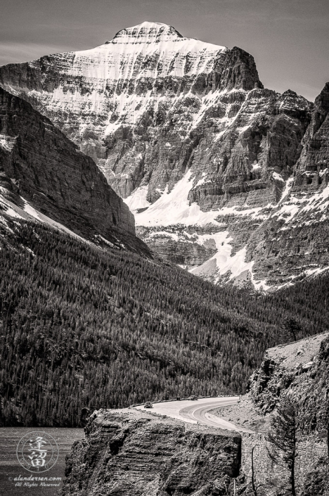 Going To The Sun Road curving around cliff before towering Little Chief mountain.