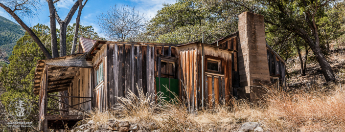 Abandoned homestead built on the side of a hill.