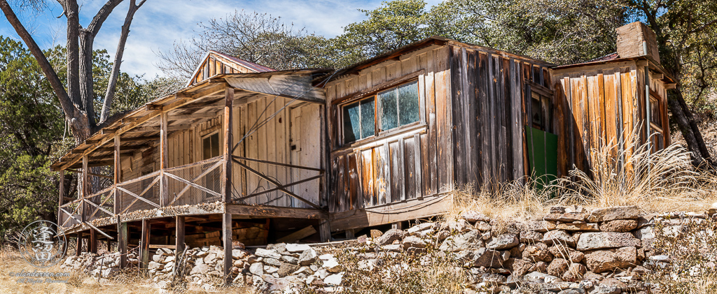 Abandoned homestead built on the side of a hill.