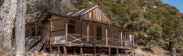 Abandoned homestead built on the side of a hill.