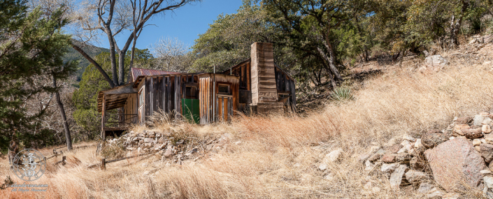 Abandoned homestead built on the side of a hill.