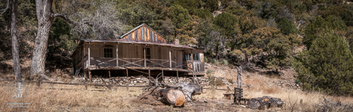 Abandoned homestead built on the side of a hill.