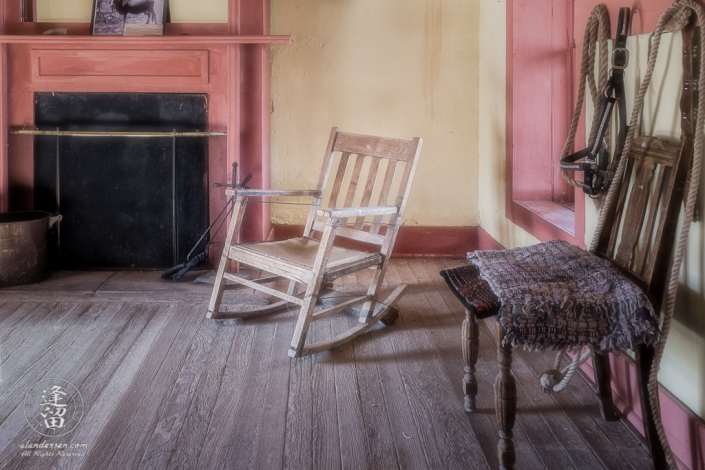 Rocking chair nestled between fireplace and window.