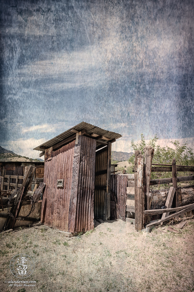 Outhouse made of corrugated tin.