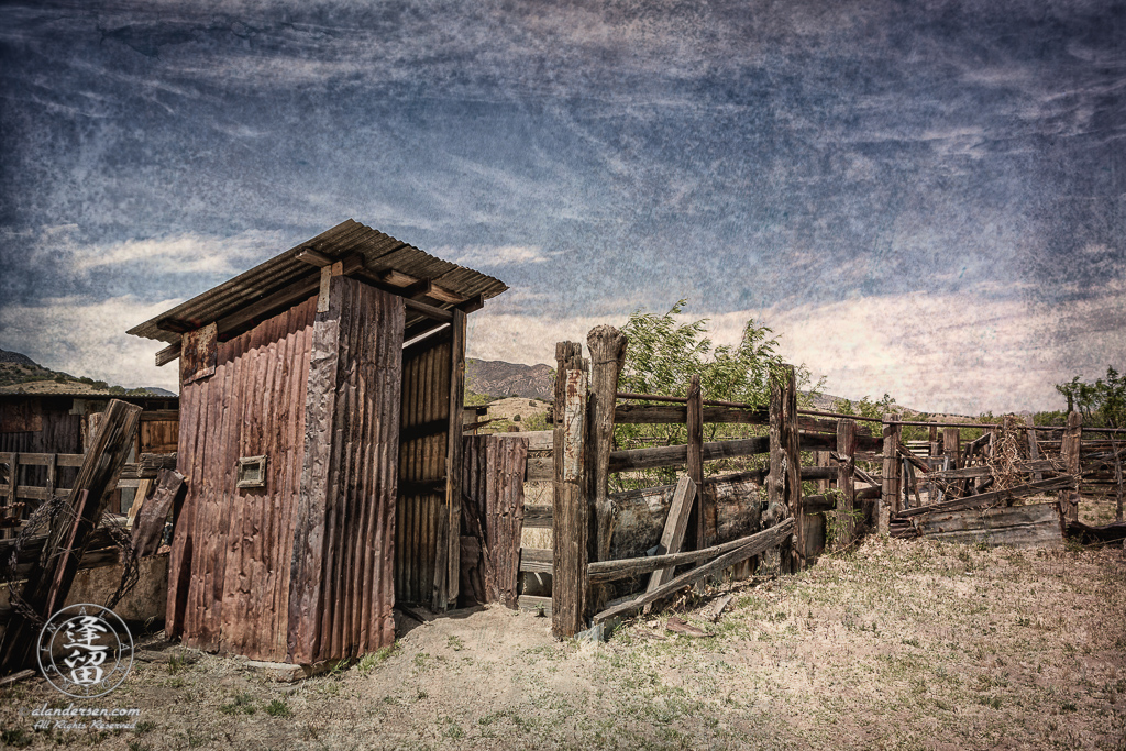 Outhouse made of corrugated tin.