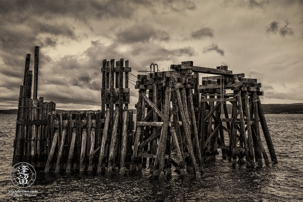 Old wooden ferry dock just off shore in historic downtown Port Townsend, Washington.