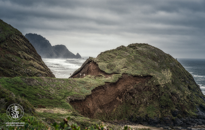 Eroded round grass-covered hill on Oregon coast.