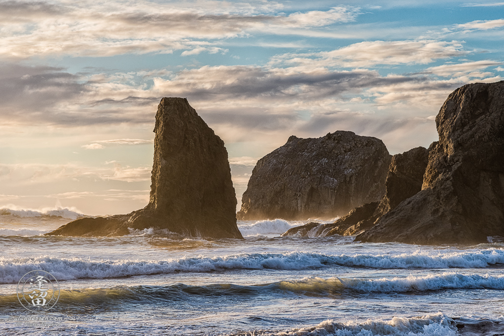 The golden rays of sunset illuminate the sea stacks at Bandon Beach near Gravel Point in Oregon.