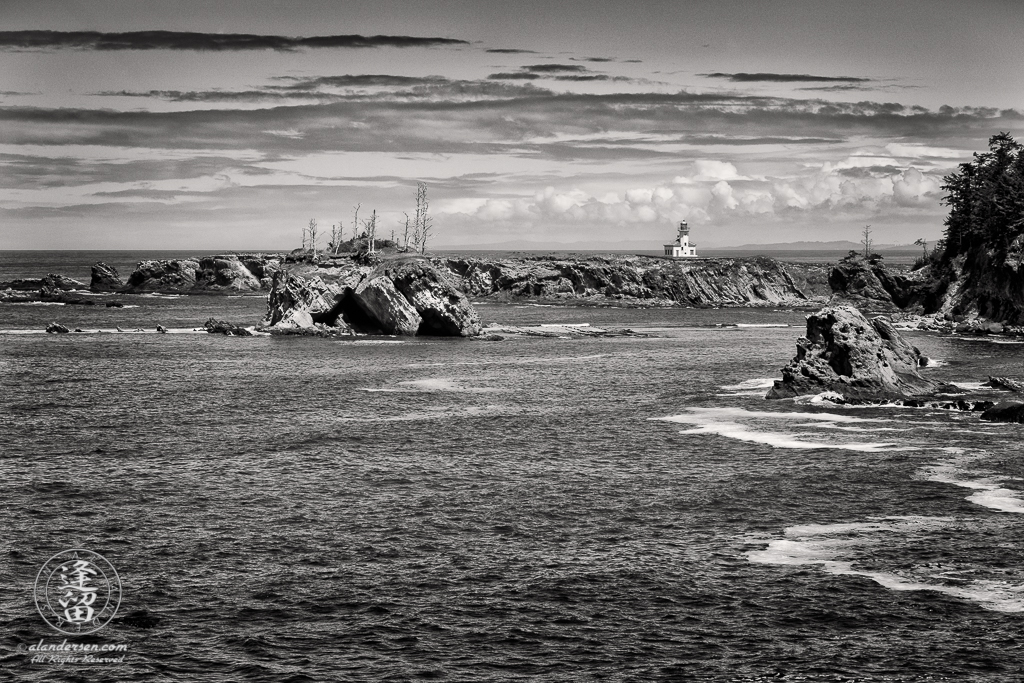 Cape Arago Lighthouse, seen from the other side of Sunset Bay on the Pacific Coast Trail to Shore Acres.