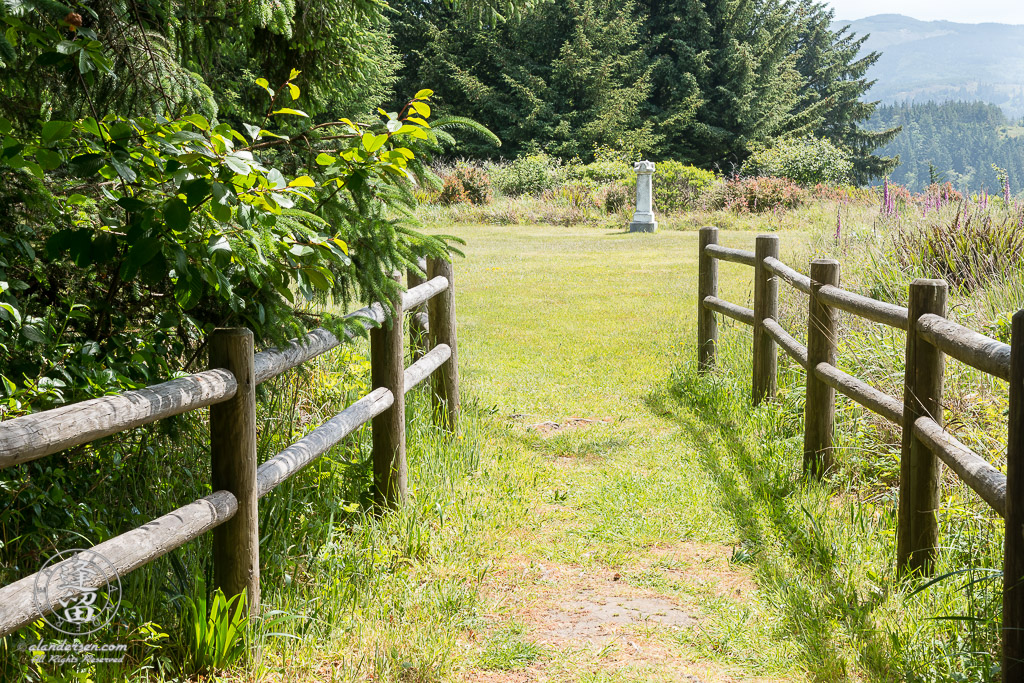 Fenced footpath leading to the Cape Blanco Pioneer Cemetery outside of Port Orford in Oregon.