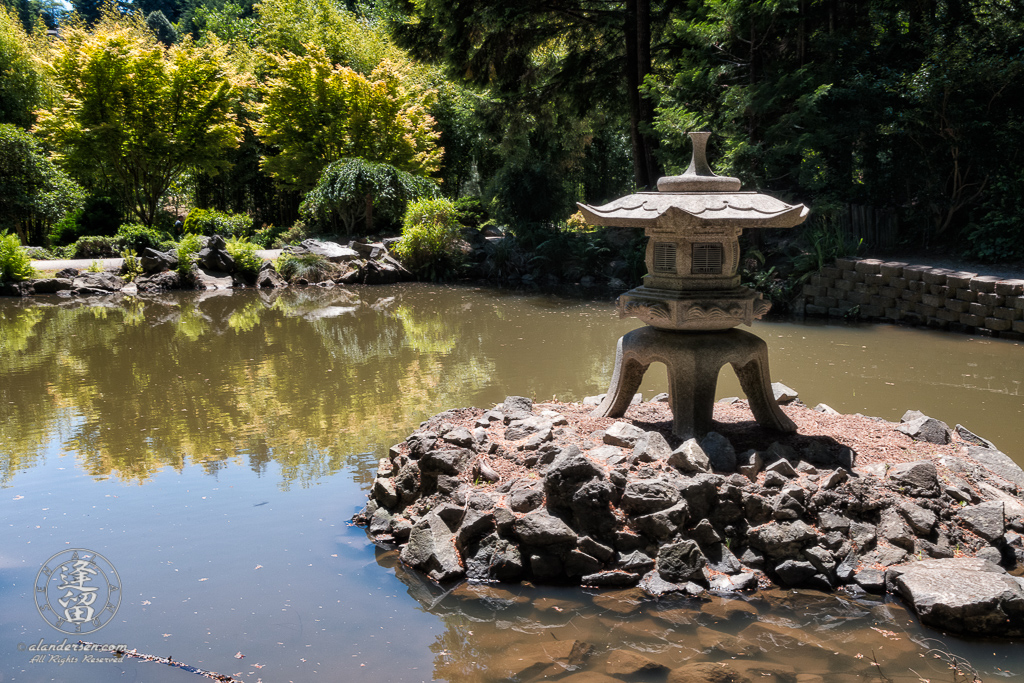 Snow Lantern on island in the Pond of Illusion in the Choshi Gardens at Mingus Park in Coos Bay, Oregon.