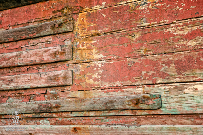 An old rusted and rotted boat in dry dock on Starfish Way, by the Marina at Crescent City in Northern California.