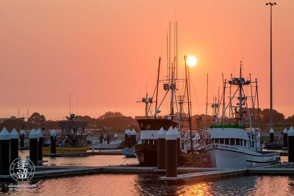 Smoke from Oregon wildfires turn the sky orange during a sunset at the Crescent City Marina in Northern California.