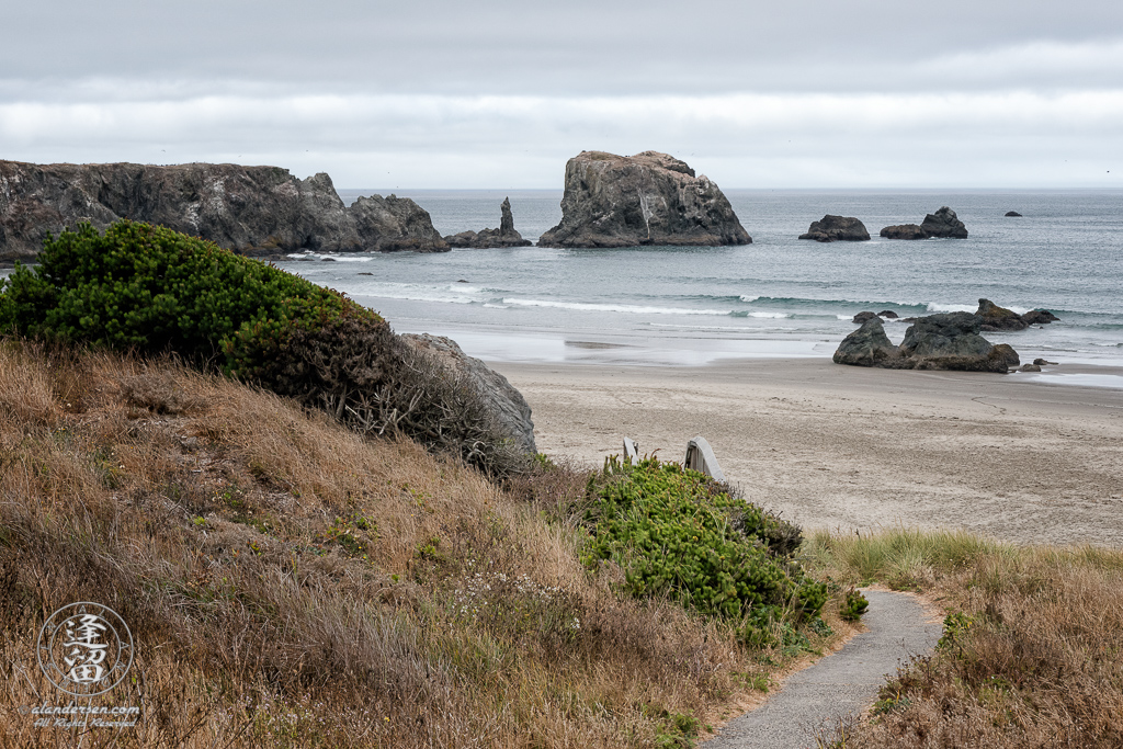 The paved path down to the beach above Coquille Point in Bandon, Oregon, looking toward Coquille Point.