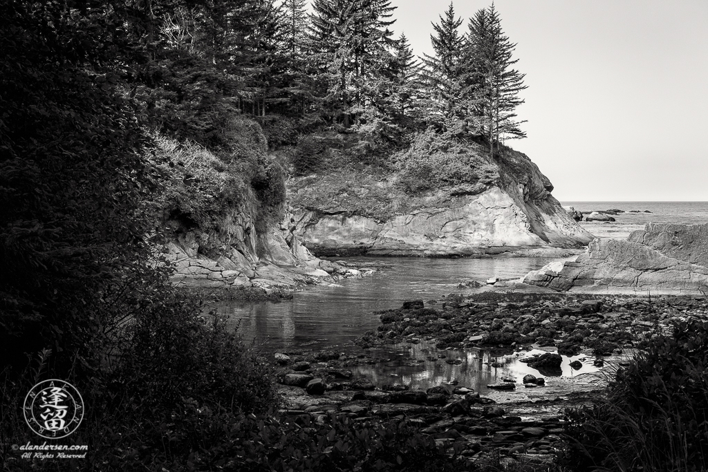 Scenic view from rock-strewn beach at Norton Gulch, which is next to Sunset Bay State Park in Oregon.