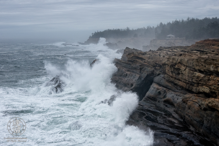 Waves pound the cliffs at Shore Acres State Park outside of Charleston in Oregon.