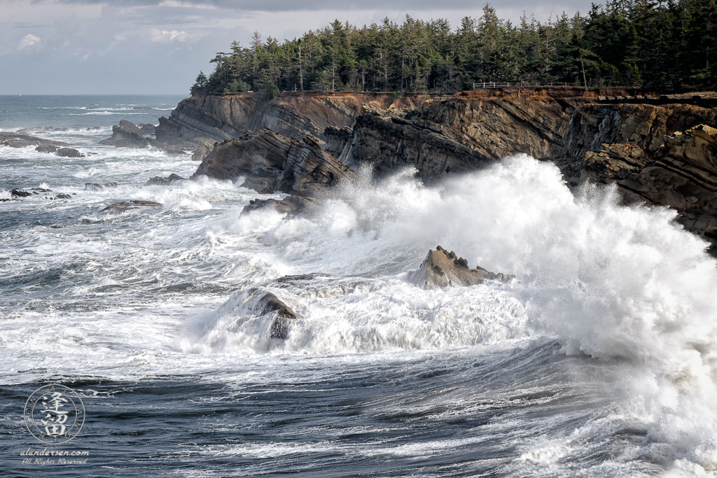 Waves pound the cliffs at Shore Acres State Park outside of Charleston in Oregon.